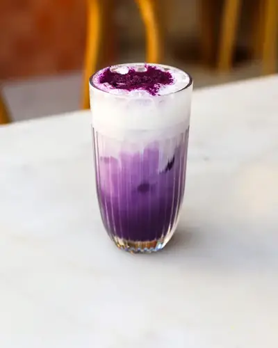 Purple iced ube latte served at the Oma coffee shop near République